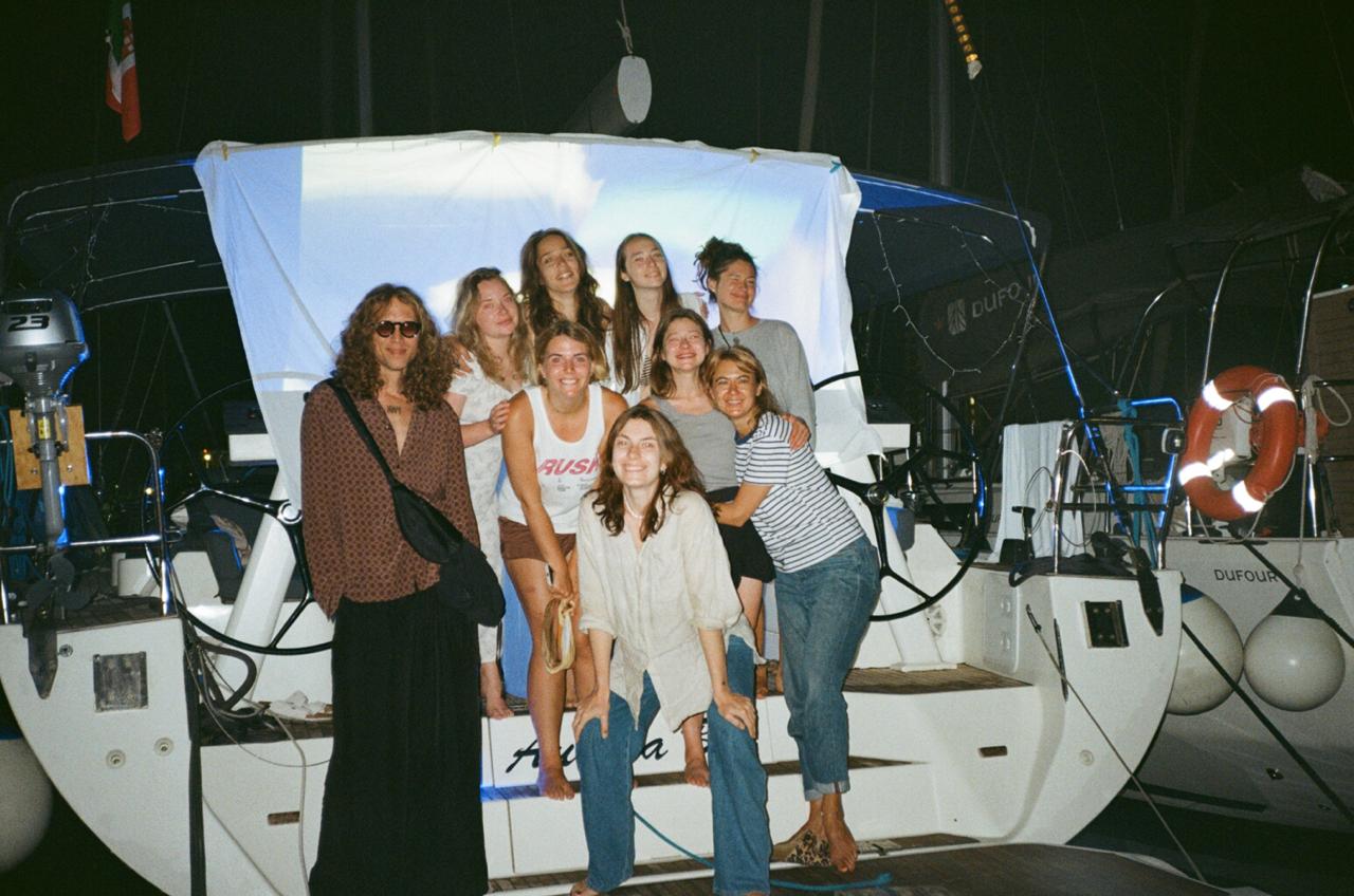 The group on the boat stern at night