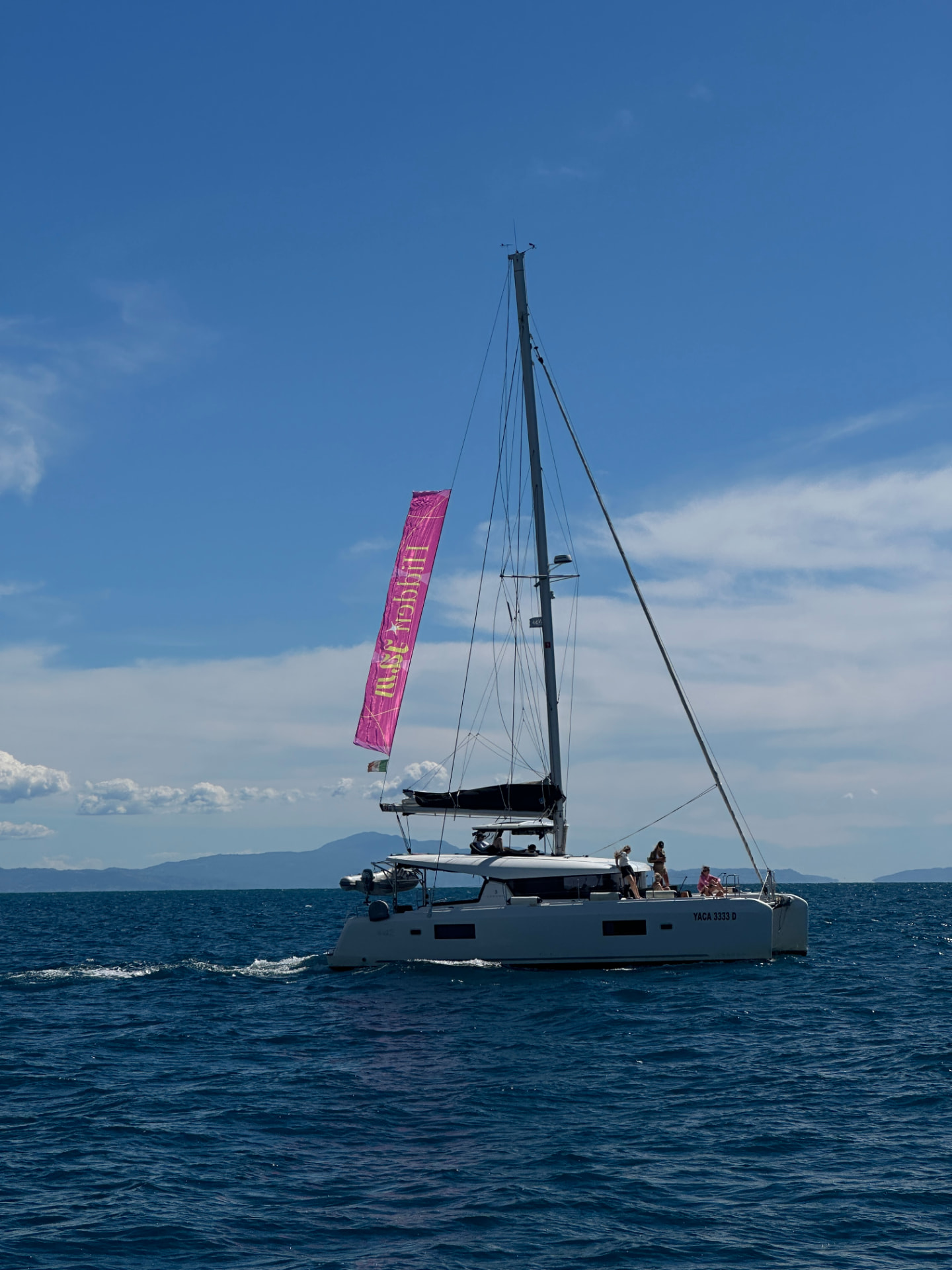Sailing catamaran under way with the crew on board