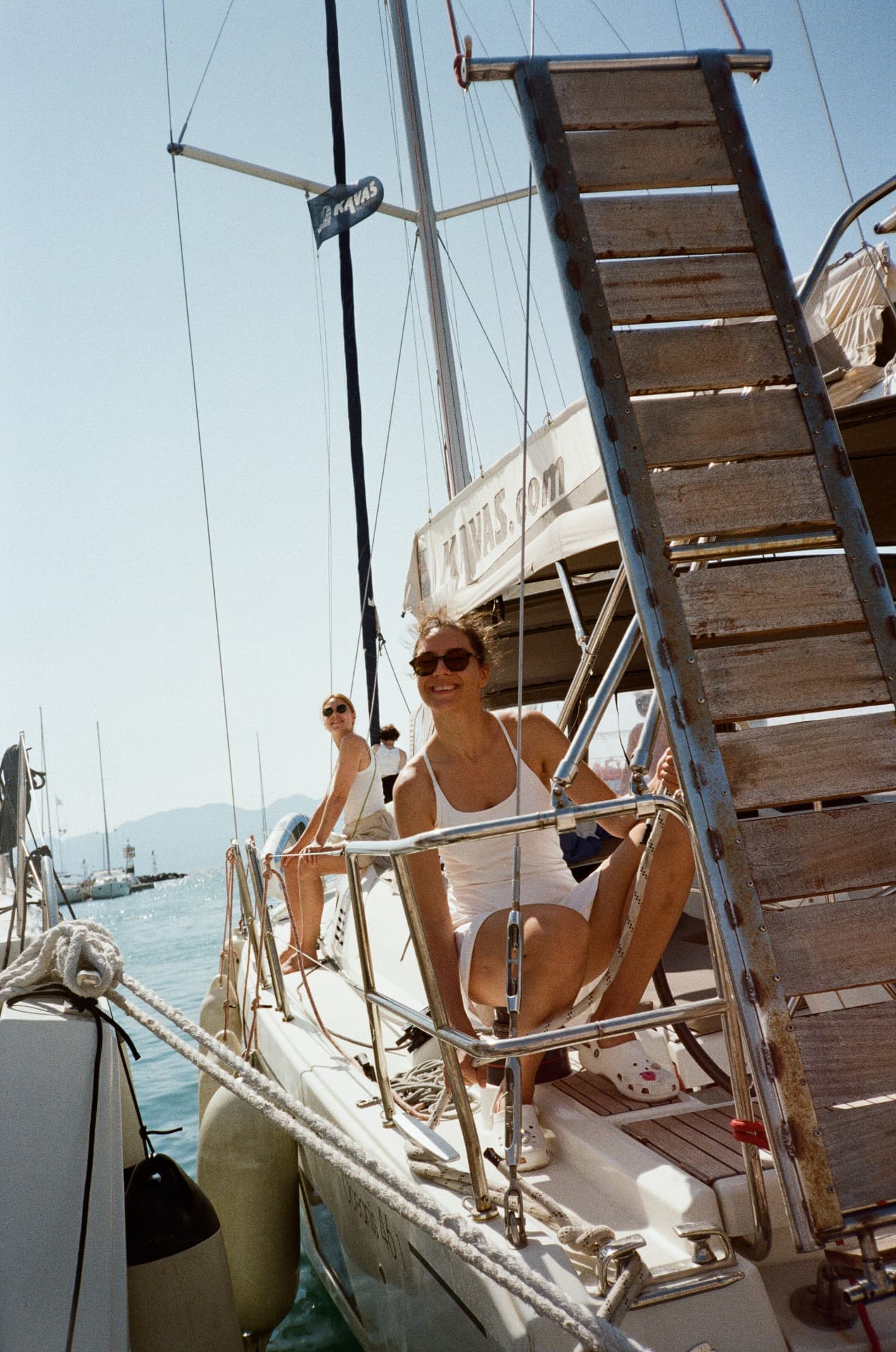 Women on the deck of a sailboat at the marina
